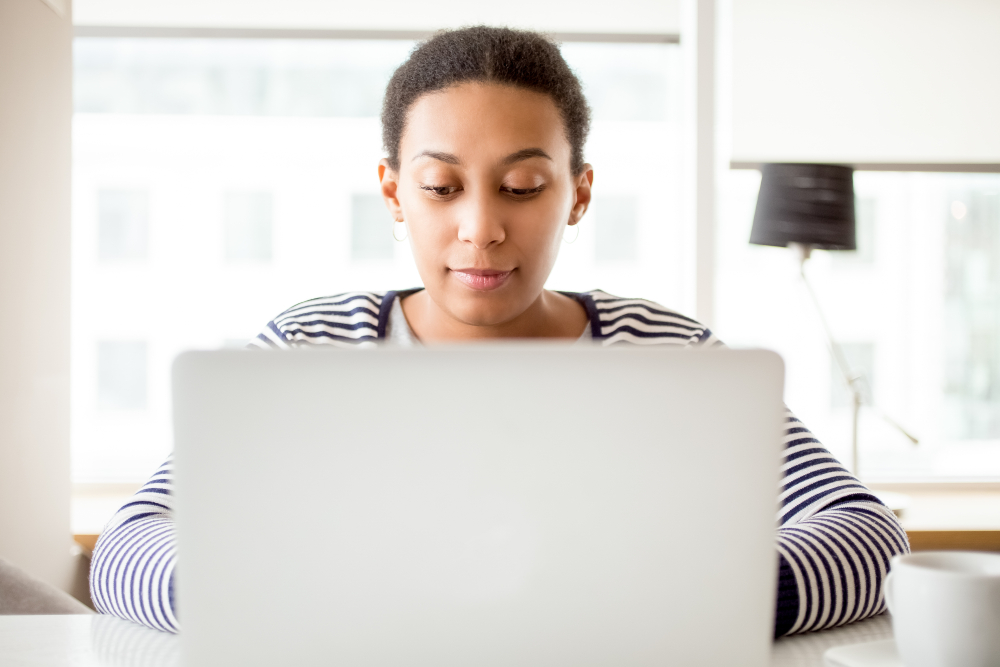 A woman using a computer at a house