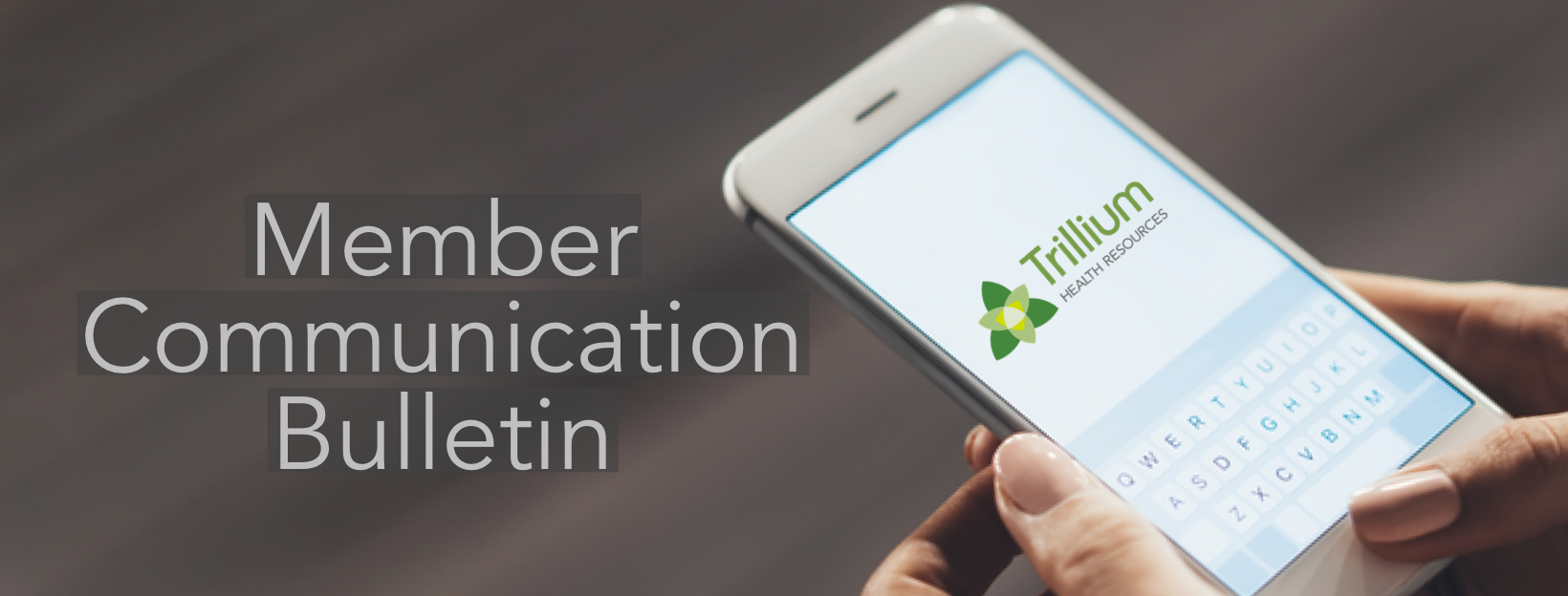 Cellphone showing Trilium logo on the cellphone screen and keyboard for texting
