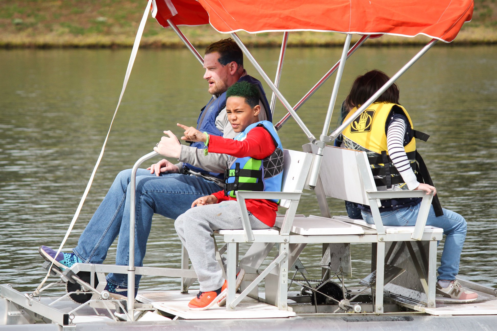 people having fun while  Pedal boating
