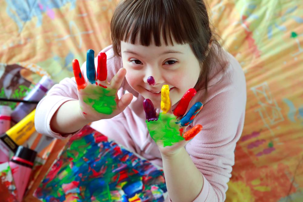 Girl with paint in her hands smiling
