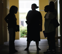 figures of women talking in a hall