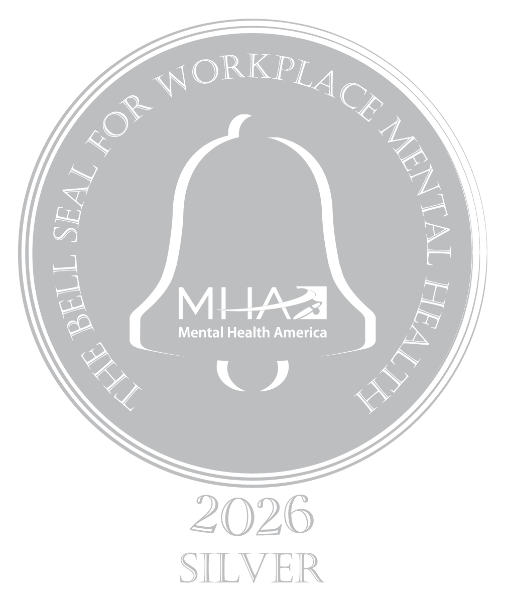 a silver circle with a bell outline in white and the words The Bell seal for workplace Mental Health