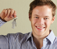 A young many holding a house keys