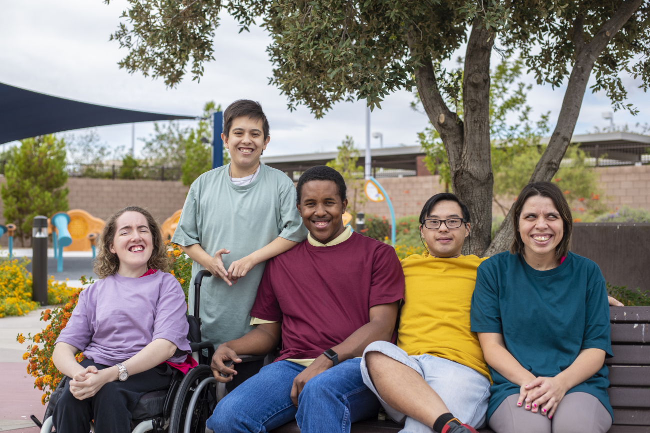 A group of people outside and smiling