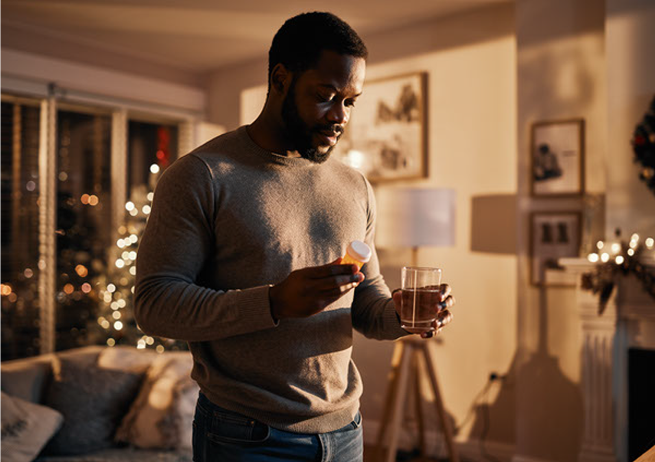 a man reading a prescription before takes medication