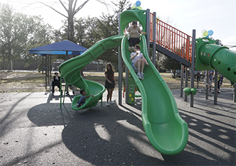 Two girls going down the slide
