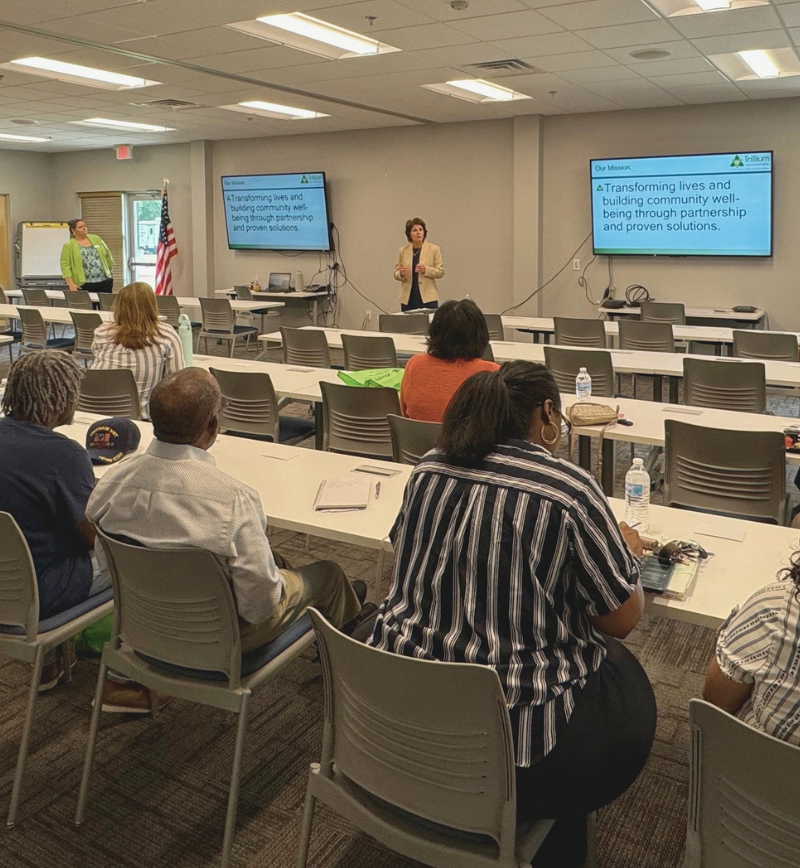 A speaker talking on a training in front of a group.
