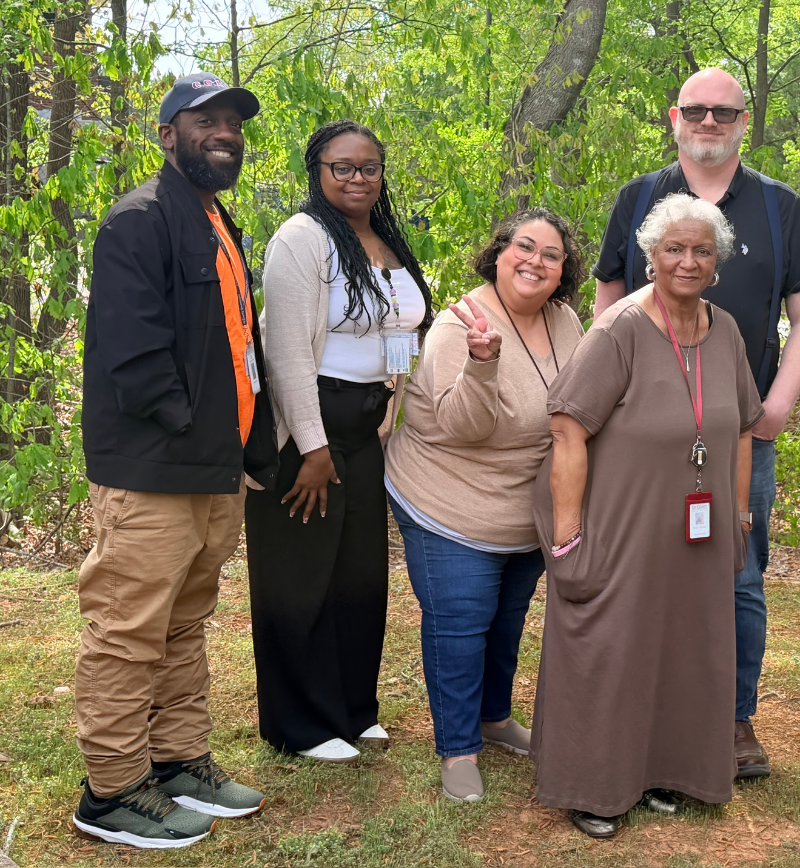Group of people smiling to the camera on the forest